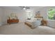 Sunlit bedroom boasting a ceiling fan, plush carpet, and stylish mid-century modern furniture at 106 Fawley Ct, Cary, NC 27519