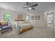 Bright bedroom featuring neutral walls, a ceiling fan, and an adjacent bathroom at 106 Fawley Ct, Cary, NC 27519
