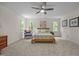Bedroom with plush carpet, comfortable chair, and natural light streaming through the windows at 106 Fawley Ct, Cary, NC 27519