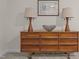 Bedroom featuring a decorative dresser, artwork, and lamps, offering a touch of modern style at 106 Fawley Ct, Cary, NC 27519
