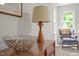 Stylish bedroom featuring wood dresser, decorative lamp, and cozy armchair near the window at 106 Fawley Ct, Cary, NC 27519