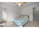 Cozy bedroom with daisy comforter and ceiling fan at 106 Fawley Ct, Cary, NC 27519