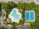 Aerial view showcasing a community pool and tennis courts nestled within lush greenery at 106 Fawley Ct, Cary, NC 27519