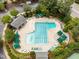 Aerial view of a large community pool surrounded by lounge chairs and umbrellas at 106 Fawley Ct, Cary, NC 27519