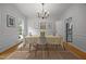 Cozy dining room featuring hardwood floors, wainscoting, and abundant natural light, perfect for entertaining at 106 Fawley Ct, Cary, NC 27519