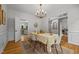 Spacious dining area with hardwood floors, chandelier, and easy access to kitchen and living spaces at 106 Fawley Ct, Cary, NC 27519
