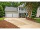 Spacious two-story home with large driveway leading to a two-car garage nestled on a landscaped lot at 106 Fawley Ct, Cary, NC 27519