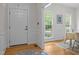 Bright entryway featuring hardwood floors, wainscoting, and natural light, creating an inviting welcome at 106 Fawley Ct, Cary, NC 27519