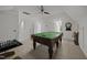 Finished game room with pool table, dartboard, ceiling fan, and chess set at 106 Fawley Ct, Cary, NC 27519