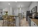 Bright kitchen boasts a breakfast bar, pendant lighting, and stainless steel appliances for a modern touch at 106 Fawley Ct, Cary, NC 27519
