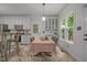 Eat-in kitchen features white cabinets, stainless appliances, a dining area, and lots of natural light at 106 Fawley Ct, Cary, NC 27519
