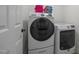 Modern laundry room featuring a Samsung washer and Maytag dryer with stacked towels at 106 Fawley Ct, Cary, NC 27519