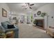 Bright living room with fireplace, ceiling fan, and seamless flow to the kitchen and breakfast nook at 106 Fawley Ct, Cary, NC 27519