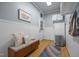 Functional mudroom with white wainscoting, wood floors, storage, and access to the exterior at 106 Fawley Ct, Cary, NC 27519