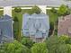 Aerial view of a house with a gray roof, screen porch, and spacious backyard nestled in a wooded area at 106 Painted Turtle Ln, Cary, NC 27519