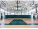 Bright, spacious basketball court with modern lighting, netting, and wood floor at 106 Painted Turtle Ln, Cary, NC 27519