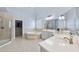 A luxurious bathroom features tile flooring, glass shower, garden tub, and a walk-in closet for ample storage at 106 Painted Turtle Ln, Cary, NC 27519