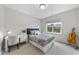 Bedroom featuring a patterned bedspread, white desk, bright light, and a view of the front yard at 106 Painted Turtle Ln, Cary, NC 27519