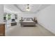 Bright bedroom featuring neutral carpet, tray ceilings, and a sitting area with large windows offering natural light at 106 Painted Turtle Ln, Cary, NC 27519