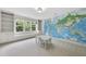 Large bonus room with custom built-ins, an oversized window seat, and a world map wall decal at 106 Painted Turtle Ln, Cary, NC 27519