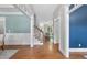 Bright entryway with hardwood floors, white trim, and a staircase leading to the upper level at 106 Painted Turtle Ln, Cary, NC 27519