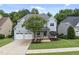 Inviting home with a two-car garage, blossoming tree, and meticulously maintained front yard at 106 Painted Turtle Ln, Cary, NC 27519