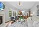 Living room opens to kitchen, featuring a fireplace and an open floor plan with ample natural light at 106 Painted Turtle Ln, Cary, NC 27519