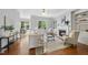 Bright living room with hardwood floors, a fireplace, and large windows overlooking the front yard at 106 Painted Turtle Ln, Cary, NC 27519