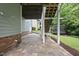 Paver patio under a home deck with view of the backyard and treeline at 106 Painted Turtle Ln, Cary, NC 27519