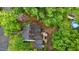 Aerial view showcasing a private backyard, outdoor deck, patio, and mature trees surrounding the property at 1105 Hawthorne Ln, Burlington, NC 27215