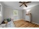 Neutral bedroom with wood floors, dresser and bright window at 1105 Hawthorne Ln, Burlington, NC 27215