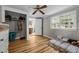 Bedroom with hardwood floors, ceiling fan, closet, and view into the dining area at 1105 Hawthorne Ln, Burlington, NC 27215