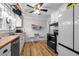 Kitchen with butcher block countertops, white cabinets, and stainless steel appliances at 1105 Hawthorne Ln, Burlington, NC 27215