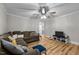 Bright living room with hardwood floors and a ceiling fan provides a comfortable atmosphere at 1105 Hawthorne Ln, Burlington, NC 27215