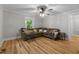 Cozy living room with hardwood floors, a ceiling fan, and lots of natural light at 1105 Hawthorne Ln, Burlington, NC 27215