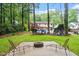 Secluded backyard features an in-ground firepit and plenty of space for outdoor activities at 1109 Buckingham Rd, Garner, NC 27529