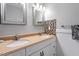 Bathroom featuring double sinks, updated cabinetry, and tiled backsplash, blending functionality with style at 1109 Buckingham Rd, Garner, NC 27529