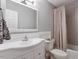 Bathroom with modern fixtures, a vanity with a sink, and a shower-tub combo, providing a functional and comfortable space at 1109 Buckingham Rd, Garner, NC 27529