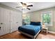 Cozy bedroom with hardwood floors, natural light, and a ceiling fan, offering a comfortable retreat at 1109 Buckingham Rd, Garner, NC 27529