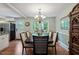Well-lit dining area with hardwood floors, large window, and a decorative cabinet, perfect for Gathering gatherings at 1109 Buckingham Rd, Garner, NC 27529