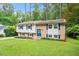 Charming two-story home featuring a mix of brick and siding, complemented by vibrant blue shutters and a well-manicured lawn at 1109 Buckingham Rd, Garner, NC 27529