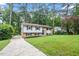 Charming two-story home with a well-manicured lawn and mature trees in a neighborhood setting at 1109 Buckingham Rd, Garner, NC 27529