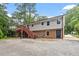 Two-story home featuring a brick foundation, light siding, upper deck, and a spacious yard at 1109 Buckingham Rd, Garner, NC 27529