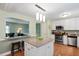 Bright kitchen featuring granite countertops, stainless steel appliances and a center island with pendant lighting at 1109 Buckingham Rd, Garner, NC 27529