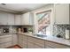 Modern kitchen boasts granite countertops, tiled backsplash, and stainless steel appliances at 1109 Buckingham Rd, Garner, NC 27529