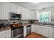 A kitchen with stainless steel appliances, including oven and dishwasher, plus tiled backsplash and granite counters at 1109 Buckingham Rd, Garner, NC 27529