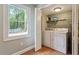 Bright laundry room features modern washer, dryer, and a window overlooking the backyard at 1109 Buckingham Rd, Garner, NC 27529