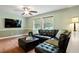 Spacious living room with hardwood floors, a ceiling fan, and plenty of natural light at 1109 Buckingham Rd, Garner, NC 27529