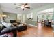 Spacious living room with hardwood floors, a ceiling fan, and plenty of natural light at 1109 Buckingham Rd, Garner, NC 27529