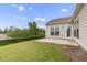 Backyard featuring a concrete patio, lawn, and manicured greenery, ideal for outdoor living and enjoyment at 118 Manning Way, Durham, NC 27703